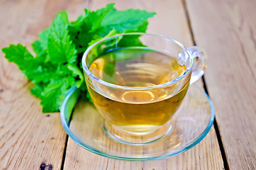 Image showing Herbal tea with melissa on a wooden board