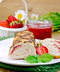 Image showing Roulade with strawberries and daisies on a board