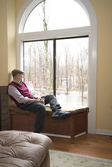 Image showing man in living room looking at flood damage