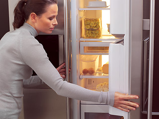 Image showing woman in front of the fridge aa