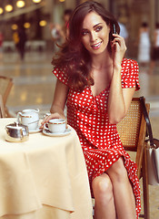 Image showing beautiful woman sitting in a Cafe with mobile