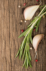 Image showing garlic and rosemary on a wooden background