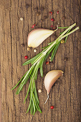 Image showing garlic and rosemary on a wooden background