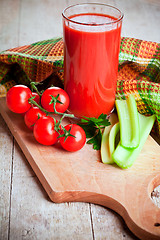 Image showing tomato juice in glass, fresh tomatoes and green celery