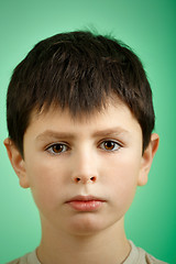 Image showing studio portrait of young boy on green background