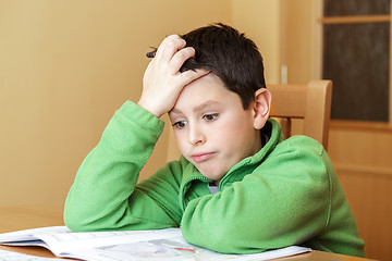 Image showing bored and tired boy doing homework