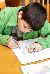 Image showing bored and tired boy doing homework