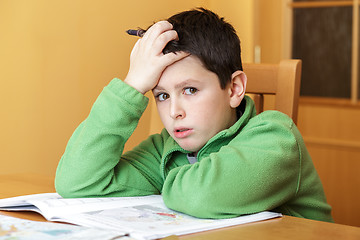 Image showing bored and tired boy doing homework