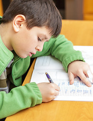 Image showing bored and tired boy doing homework