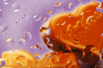 Image showing Water drop with chocolate heart on violet background