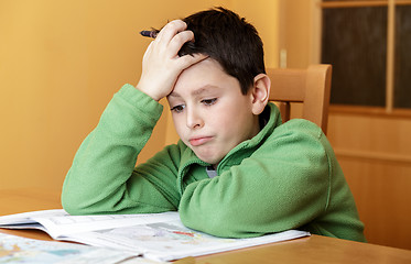 Image showing bored and tired boy doing homework
