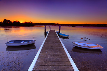 Image showing Sunset moorings and boat jetty in a little cove Australia