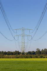 Image showing Electric powerlines across a beautiful field