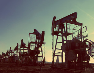 Image showing oil pumps silhouette - vintage retro style