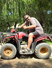 Image showing fun overweight man on quad bike