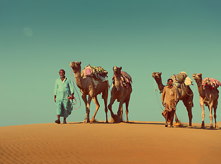 Image showing cameleers with camels in desert  - vintage retro style