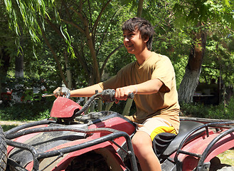 Image showing happy asian boy on quad bike atv