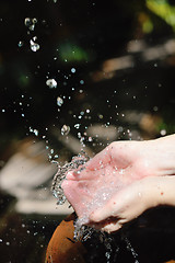 Image showing splashing fresh water on woman hands