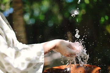 Image showing splashing fresh water on woman hands