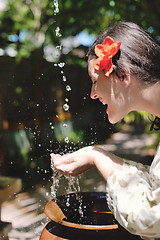 Image showing splashing fresh water on woman hands