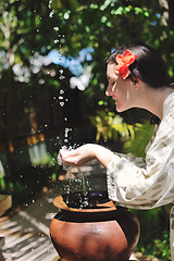 Image showing splashing fresh water on woman hands