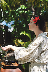 Image showing splashing fresh water on woman hands