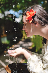 Image showing splashing fresh water on woman hands