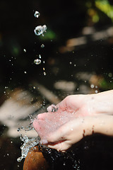 Image showing splashing fresh water on woman hands