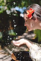 Image showing splashing fresh water on woman hands