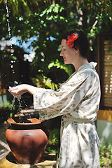 Image showing splashing fresh water on woman hands