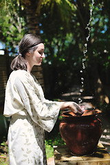 Image showing splashing fresh water on woman hands