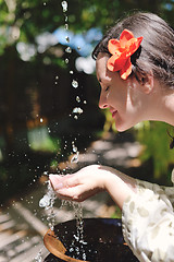 Image showing splashing fresh water on woman hands