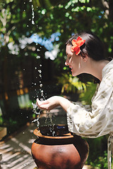 Image showing splashing fresh water on woman hands