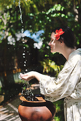 Image showing splashing fresh water on woman hands