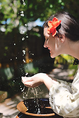 Image showing splashing fresh water on woman hands