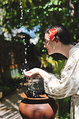 Image showing splashing fresh water on woman hands