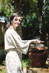 Image showing splashing fresh water on woman hands