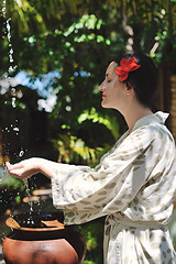 Image showing splashing fresh water on woman hands