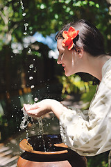 Image showing splashing fresh water on woman hands