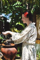 Image showing splashing fresh water on woman hands