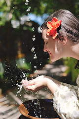 Image showing splashing fresh water on woman hands