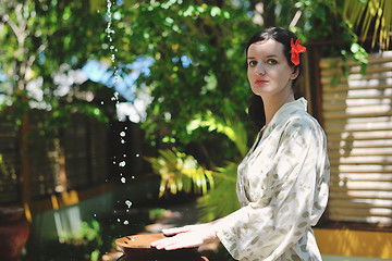 Image showing splashing fresh water on woman hands