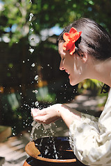 Image showing splashing fresh water on woman hands