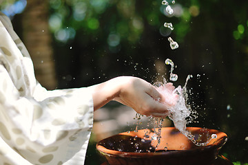 Image showing splashing fresh water on woman hands