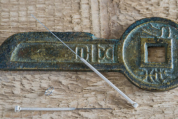 Image showing Acupuncture needles with antique chinese coin