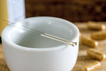 Image showing acupuncture needles with mortar and chinese herbal pills