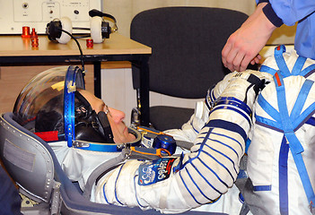 Image showing Don Pettit During Space Suit Leak Check