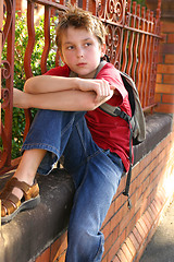 Image showing Boy with schoolbag slung over shoulder