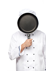 Image showing Chef with a pan in her face on white background