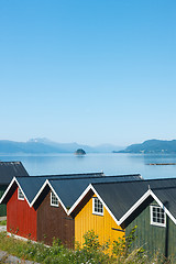 Image showing Colorful camping cabins on the fjord shore